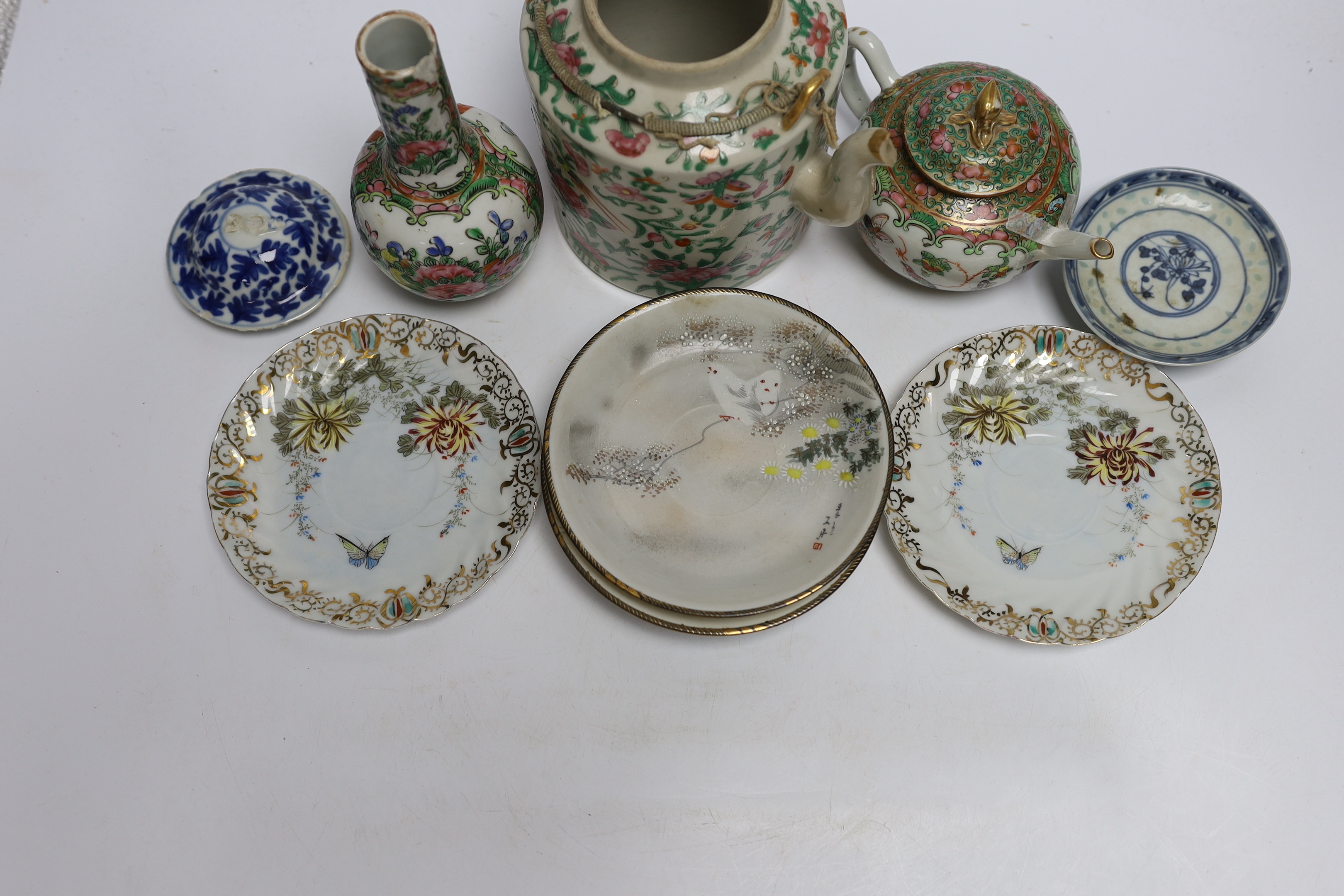 A collection of Chinese and Japanese ceramics including two famille rose teapots, a vase, four saucers, etc. (8)